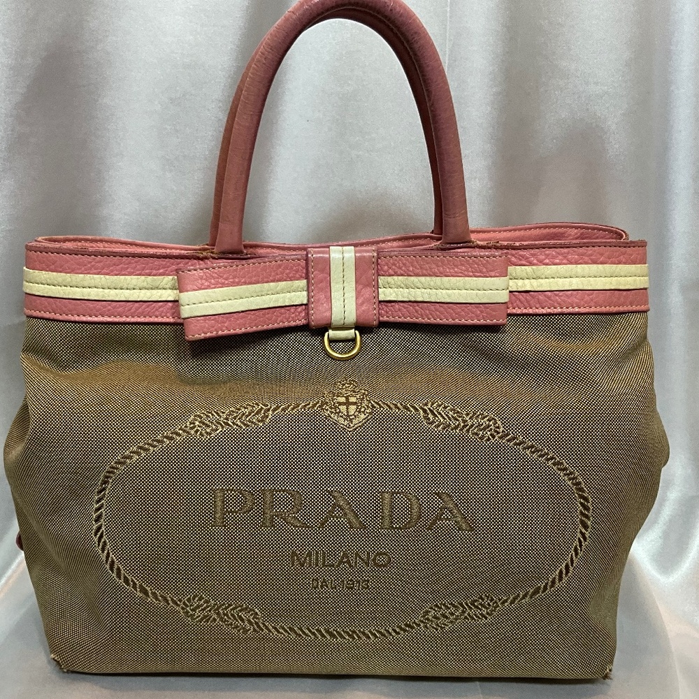 Prada, beige canvas Monogram tote with pink leather bow and trim.  173-H4g